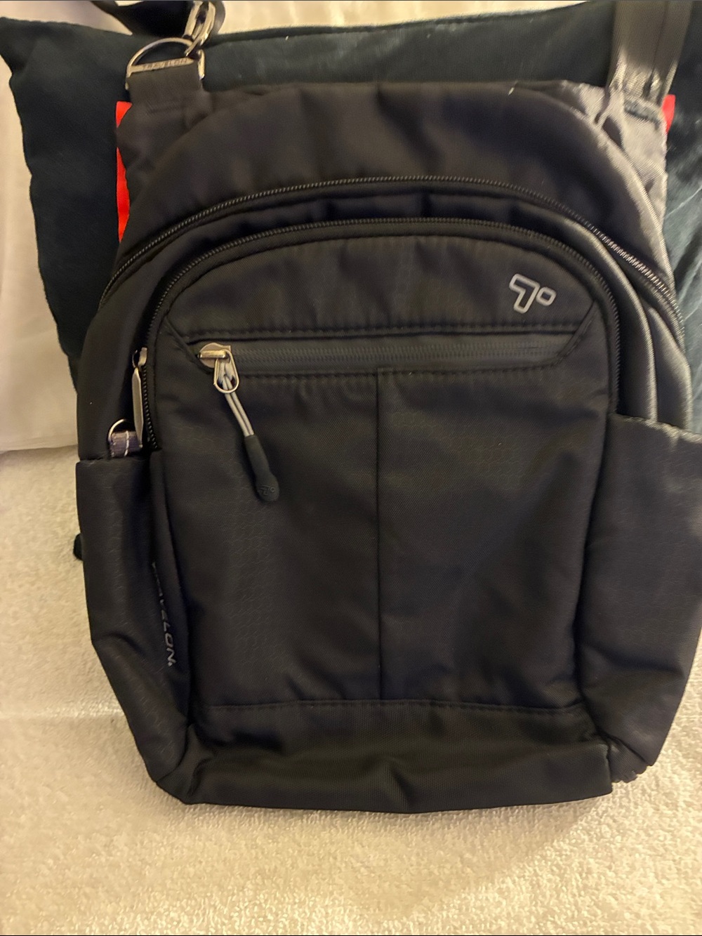 Travelon Black Sling Backpack with Red Accent